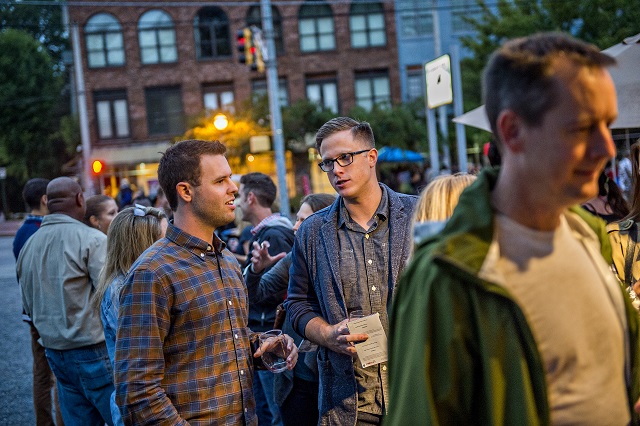 Jacob Fish (left) talks with Nathan Kimball as they wait in line for their next glass of wine during the Kirkwood Wine Stroll on Friday. Photo: Jonathan Phillips