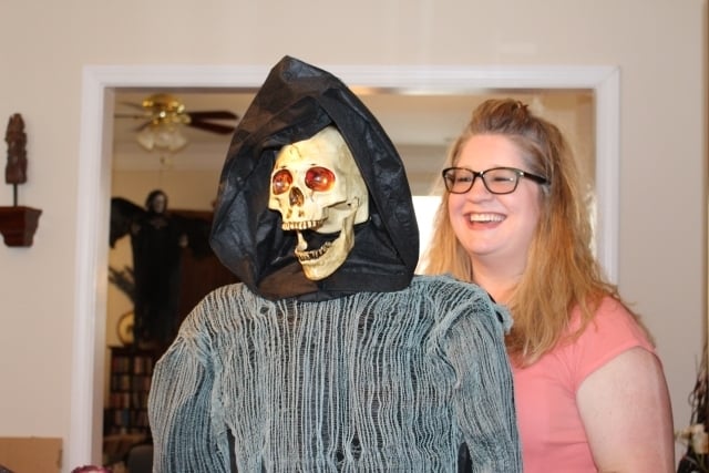 Jones-Mitchell said another inexpensive decorating idea for the window is to take a lamp or art easel, drape a newspaper-stuffed jacket over it and put a cheap Halloween mask on it. Photo by Dena Mellick