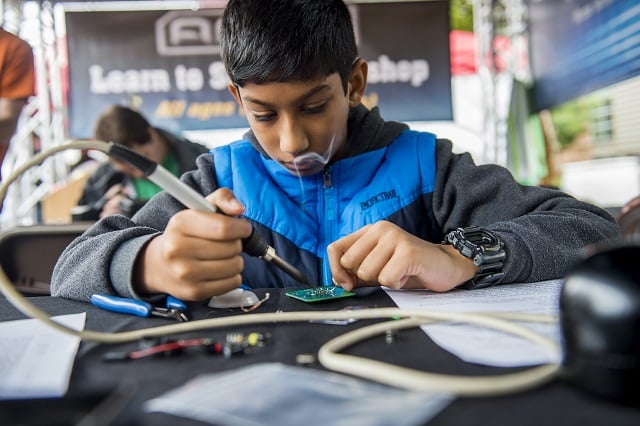 Ronny Berry learns to solder during the 2015 Atlanta Maker Faire in Decatur. File Photo: Jonathan Phillips