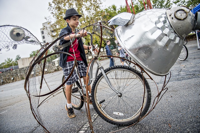 Garrett Hinton rides a bicycle made to look like a flying pig during the Atlanta Maker Faire in Decatur on Saturday. Photo: Jonathan Phillips