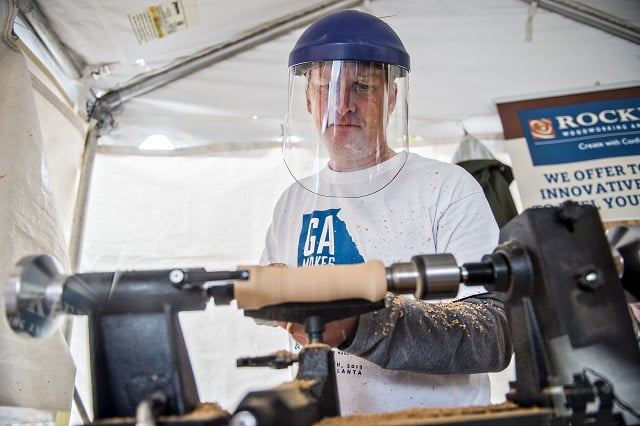 Dan Cary uses a mini lathe to cut into a piece of wood during the Atlanta Maker Faire in Decatur on Saturday. Photo: Jonathan Phillips