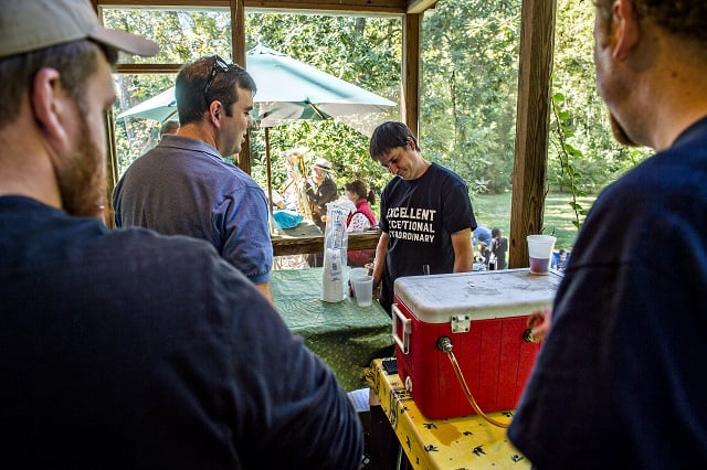 DeSha Dean (center) pours free beer during the Oakhurst Porch Fest on Sunday. Photo: Jonathan Phillips