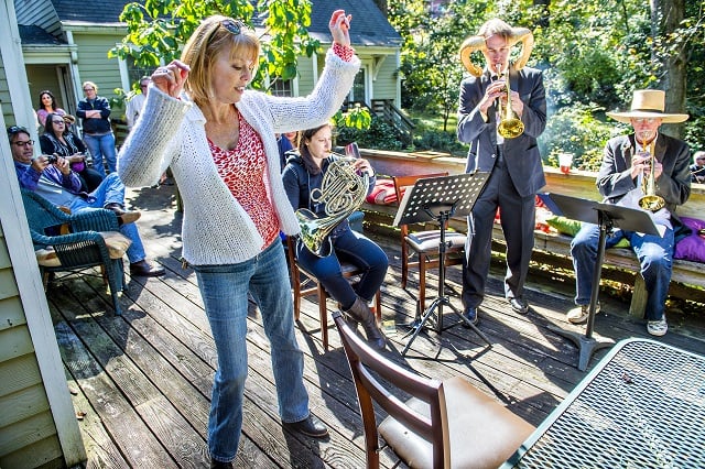 Birda Ringstad (left) dances as Weapons of Brass Destruction performs during the Oakhurst Porchfest File Photo: Jonathan Phillips