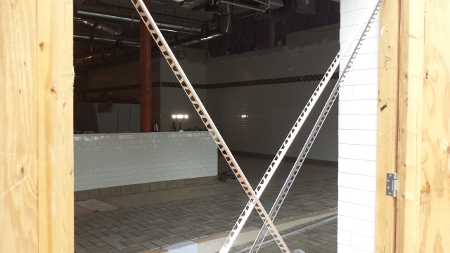 White tile with a yellow and black tile border is now installed in the Decatur Waffle House under construction. November 2015, Photo by Dena Mellick