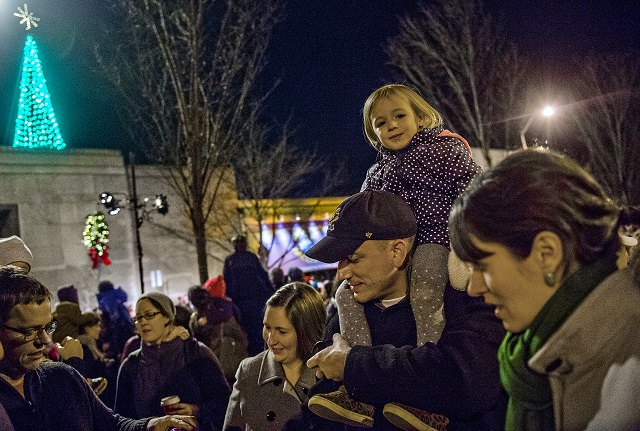 Amelia Gieraltowski sits on her father Matt's shoulders after the lighting of the tree in downtown Decatur on Thursday. Photo: Jonathan Phillips