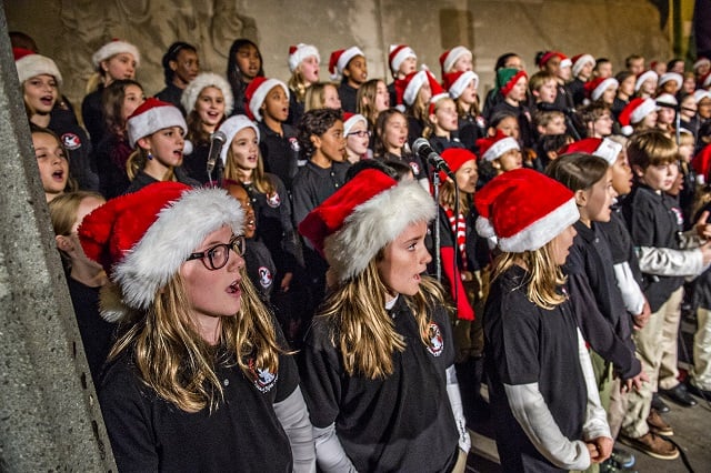 Kathleen O'Shea (left) and Madelyn McElroy perform with the 4/5 Academy chorus during the annual tree lighting in downtown Decatur on Thursday. Photo: Jonathan Phillips