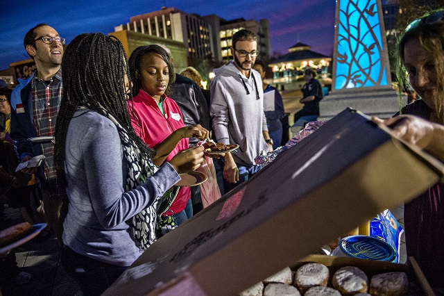 Rifqa Sa'Aadat (left) and Ashanti Aaliyah fill their plates with potato latkes during the Chanukah celebration in Decatur Square on Thursday. Photo: Jonathan Phillips
