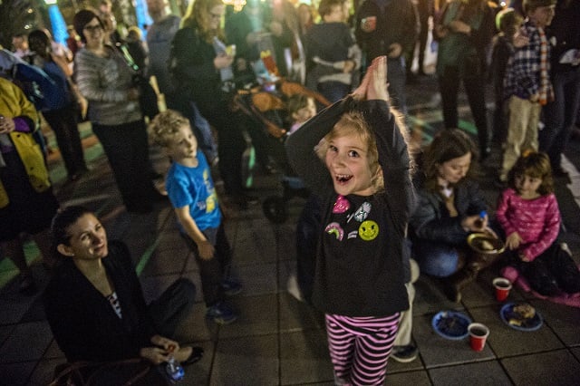 Delilah Wolf spins around to a dreidel song during the Chanukah celebration in Decatur Square on Thursday. Photo: Jonathan Phillips