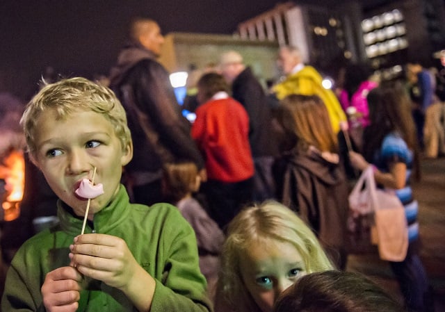 Sydney Rogers (left) eats his marshmallow off of a stick during the annual marshmallow roast at Decatur Square on Thursday. Photo: Jonathan Phillips