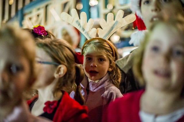 Amelia Russell (center) sings Christmas carols during the annual marshmallow roast at Decatur Square on Thursday. Photo: Jonathan Phillips