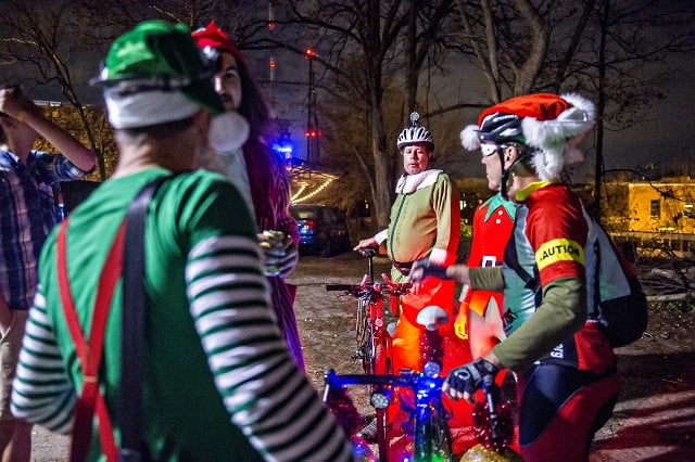 Dressed as an elf, Wes Lucas (center) gathers at Atlanta Beltline Bicycle with around 50 other cyclists before the annual Atlanta Christmas Ride on Wednesday evening. Photo: Jonathan Phillips