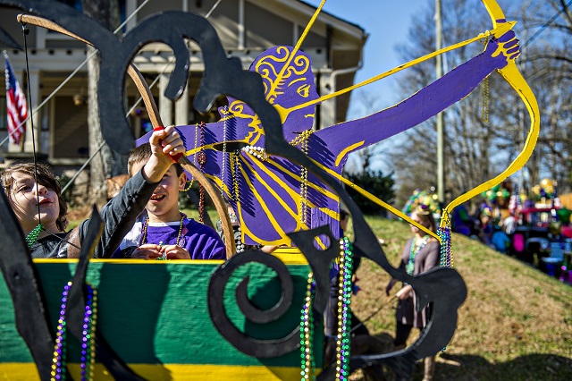 Xander Golubic (left) practices launching beads into the air with a bow before the start of the first annual LantaGras Parade in Kirkwood on Saturday. Photo: Jonathan Phillips