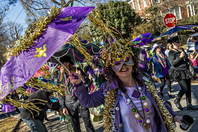 Chantelle Rytter (center) dances down the street as she participates in first annual LantaGras Parade in Kirkwood on Saturday. Photo: Jonathan Phillips