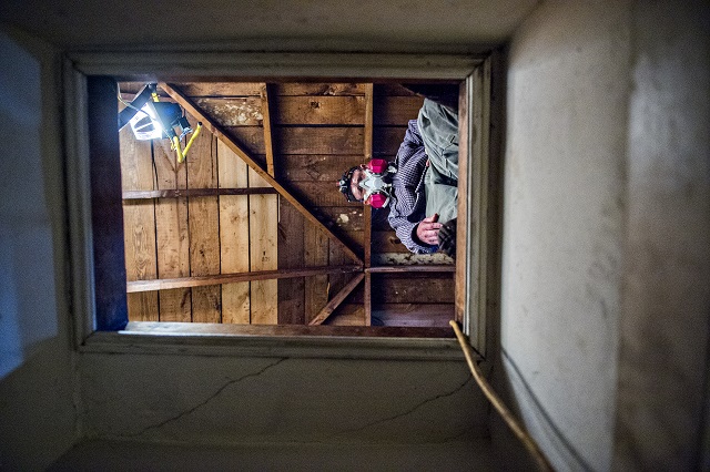 Frank Burdette works in the attic of a house off of S. McDonough St. in Decatur during the 14th annual Martin Luther King Jr. Service Project on Sunday. Photo: Jonathan Phillips