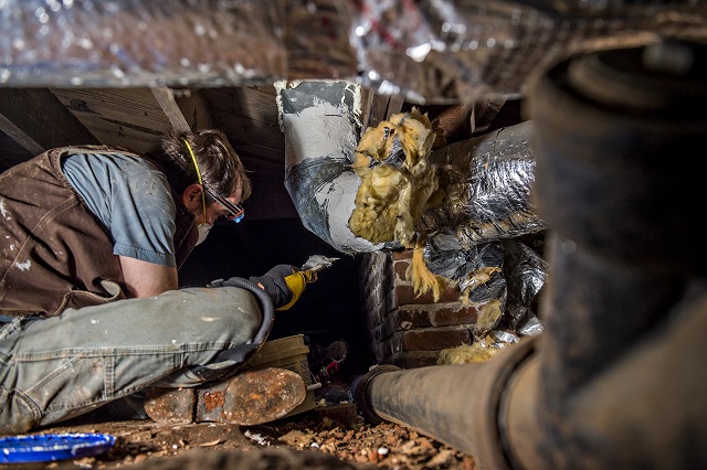 Scott Lee helps seal air conditioning ducts in the crawl space of a house during the 14th annual Martin Luther King Jr. Service Project on Sunday. Photo: Jonathan Phillips