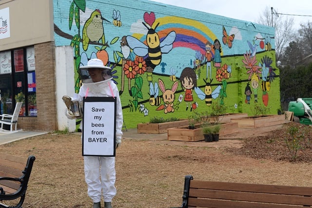 Oakhurst beekeeper Deborah Palmer stands in front of a new mural in Oakhurst. Photo by Dan Whisenhunt