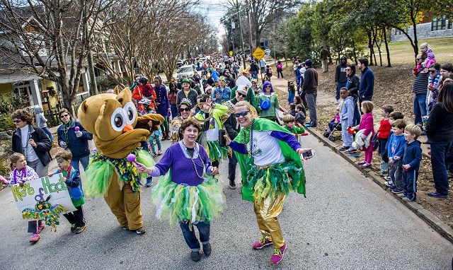 Jane Miller (center) and Kira Wilsterman march down Mead Rd. during the Mead Rd. Mardi Gras Parade on Saturday. Photo: Jonathan Phillips