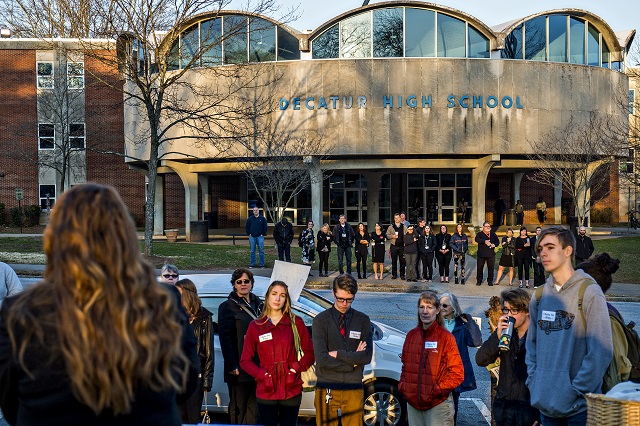Teachers and faculty at Decatur High School stand in front of the school listening to an outpouring of support for Susan Riley during the Rally for Riley on Monday morning. Photo: Jonathan Phillips