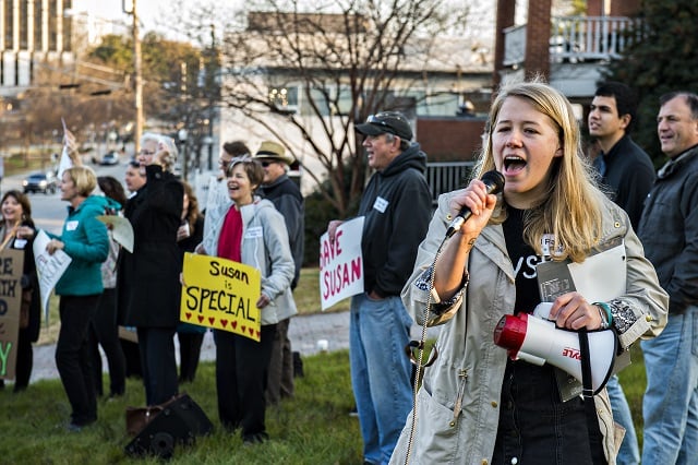 Sara Stubbs (right), one of the organizers of the Rally for Riley, leads the crowd gathered across from Decatur High School in support of Susan Riley in chants and cheers on Monday morning. Photo: Jonathan Phillips