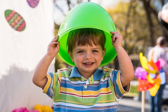 Finn Leahy plays with a giant green egg before the East egg hunt begins.
