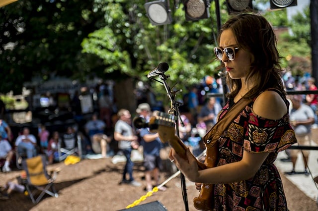 Carly Gibson plays guitar as Gibson Wilbanks performs on stage during the Decatur Arts Festival on Saturday. Photo: Jonathan Phillips
