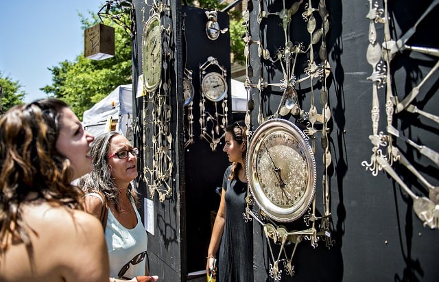 Robin Raffa (center) and her daughter Rebecca check out one of the numerous artist booths during the Decatur Arts Festival on Saturday. Photo: Jonathan Phillips