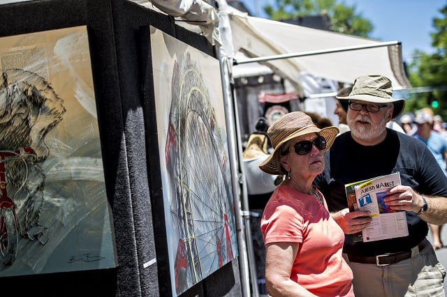 Gene Turner and her husband John decide which booth to stop at next during the Decatur Arts Festival on Saturday. Photo: Jonathan Phillips
