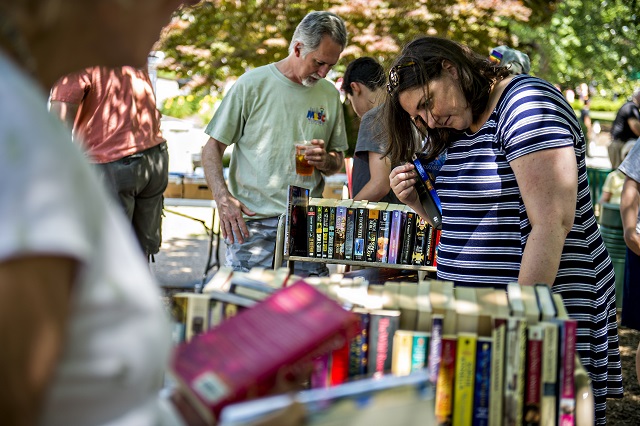 Melissa Kotun (right) and Charles Weyant check out books for sale during the Decatur Arts Festival on Saturday. Photo: Jonathan Phillips