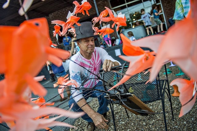 Dave Lind (left) prepares his goldfish lantern as he waits for the start of the third annual Decatur Lantern Parade on Friday. Photo: Jonathan Phillips