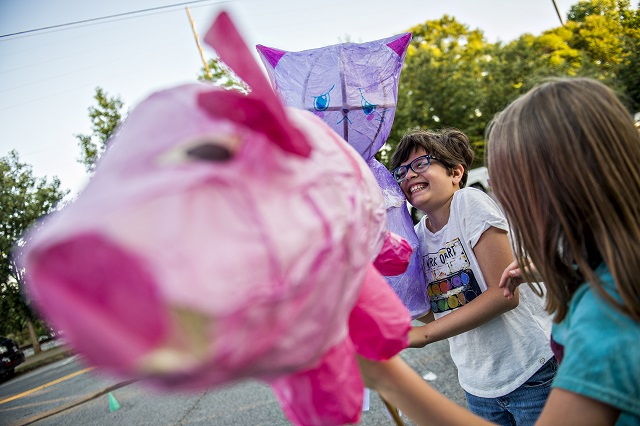 Maria Levin (left) laughs with her friend Skyler Marks as they wait for the start of the third annual Decatur Lantern Parade on Friday. Photo: Jonathan Phillips