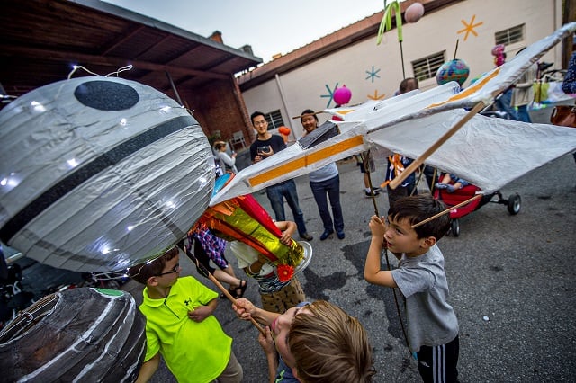 Alex Park (right) runs his X-Wing lantern into the Death Star as he waits for the start of the third annual Decatur Lantern Parade on Friday. Photo: Jonathan Phillips