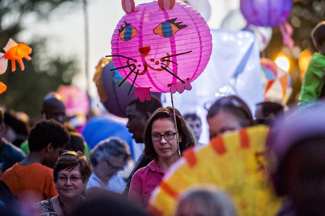 Barbara Herrera (center) holds a cat lantern as she waits for the start of the third annual Decatur Lantern Parade on Friday. Photo: Jonathan Phillips