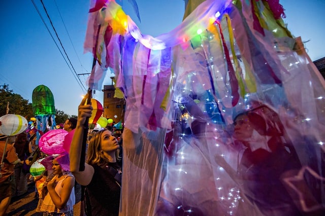 Meredith Barna (left) helps Beverly Beyer with her lantern as they wait for the start of the third annual Decatur Lantern Parade on Friday. Photo: Jonathan Phillips
