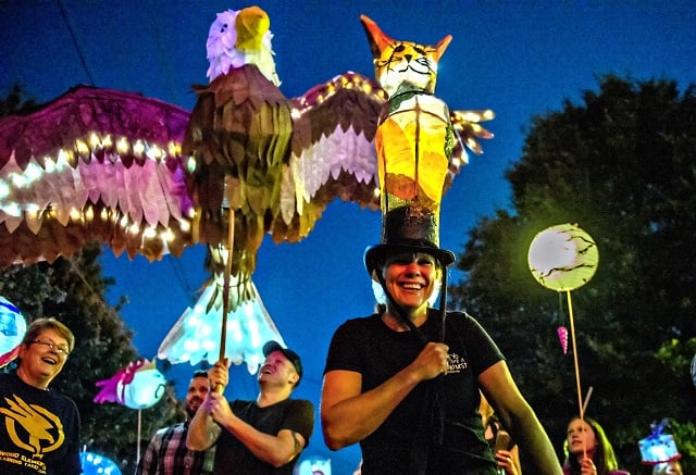 Kira Wilsterman (right) and Nick Madden walk down E. Ponce during the third annual Decatur Lantern Parade on Friday. Photo: Jonathan Phillips