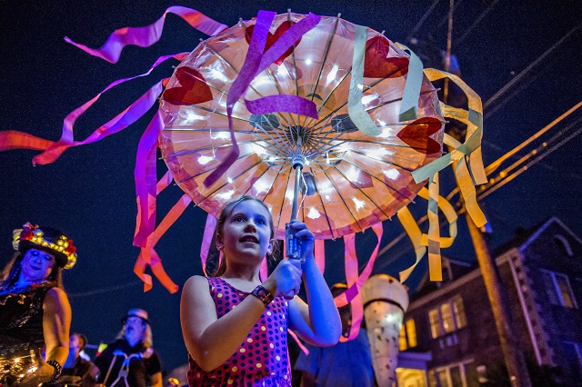 Layne Huey (center) carries an umbrella lantern during the third annual Decatur Lantern Parade on Friday. Photo: Jonathan Phillips
