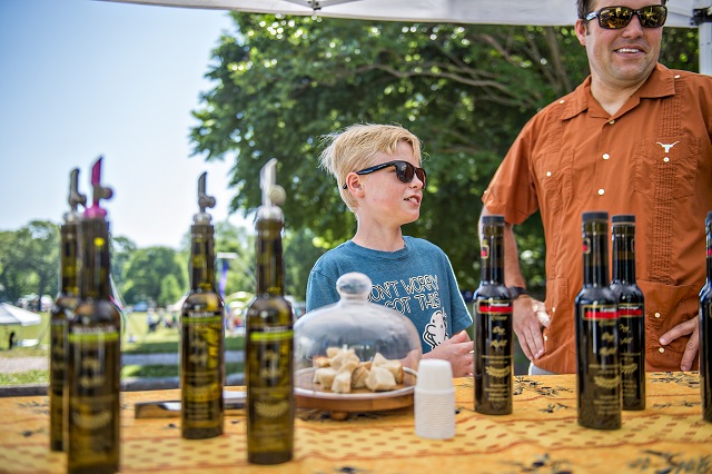 Lyndon Warren and his father David try samples of olive oil during the Kirkwood Spring Fling on Saturday. Photo: Jonathan Phillips