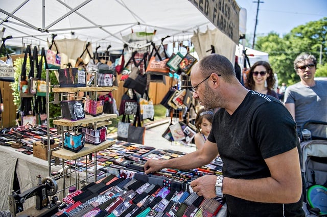 Sammy Brewer (center) checks out wallets at one of the artist booths during the Kirkwood Spring Fling on Saturday. Photo: Jonathan Phillips