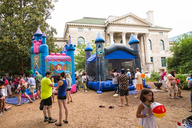 The bounce houses in front of the DeKalb County courthouse are a major attraction at the beach party.
