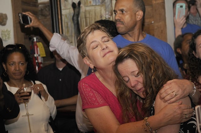 (left to right) Linda McCulloch, Allyson Hepburn, embrace at a watch party for Steve Bradshaw on July 26. Photo by Rebecca Breyer