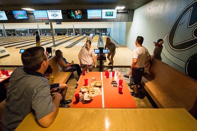 Families enjoy food and bowling on the opening night.