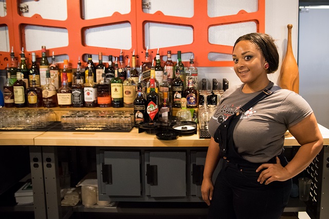 Kayla Thompkins prepares for the first customers at the bar.