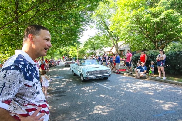 Avondale Estates City Manger Clai Brown looks on as the parade passes by. Photo by Travis Hudgons