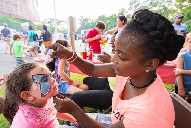 Miya paints Alexandra's face at the LAC tent. Photo by Steve Eberhardt