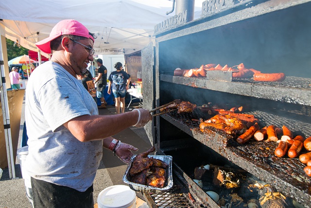 Reyes Morales of Williamson Bros. BBQ works at the Decatur BBQ, Blues, & Bluegrass Festival. Photo by Steve Eberhardt