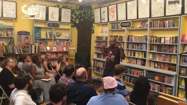 Zack Linly performs his poem "Target" at Little Shop of Horrors in downtown Decatur, during the National Poetry Slam. Photo by David Schick 