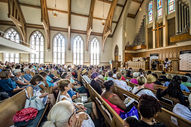 Hundreds of people sit in the pews of Decatur Presbyterian Church as they listen to author Jacqueline Woodson read an excerpt from her newest novel "Another Brooklyn" during the Decatur Book Festival on Saturday. Photo: Jonathan Phillips