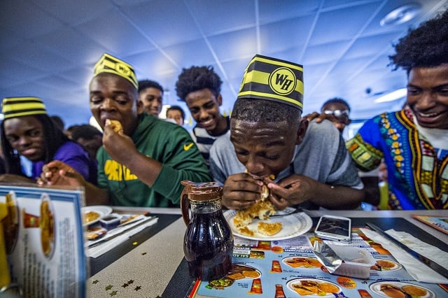 Jonah Wildgoose makes a move to tie Jason McLin during the first round of the waffle eating contest at the Waffle House off of Decatur Square on Friday. Photo: Jonathan Phillips