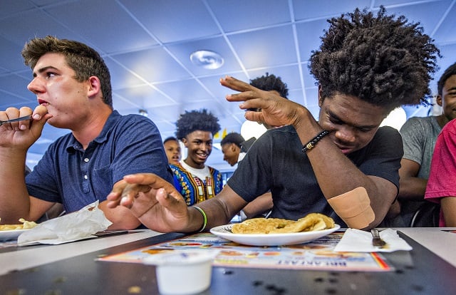 Jeremy Slaughter (right) taps out as Cole Baker continues to eat during the waffle eating contest at the Waffle House off of Decatur Square on Friday. Photo: Jonathan Phillips