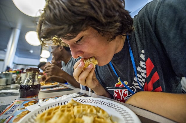 Jacob Poe shoves a waffle into his mouth as the final seconds of the third round tick down during the waffle eating contest at the Waffle House off of Decatur Square on Friday. Photo: Jonathan Phillips