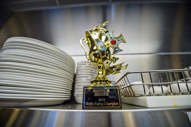 The trophy and crown are up for grabs during the waffle eating contest at the Waffle House off of Decatur Square on Friday. Photo: Jonathan Phillips